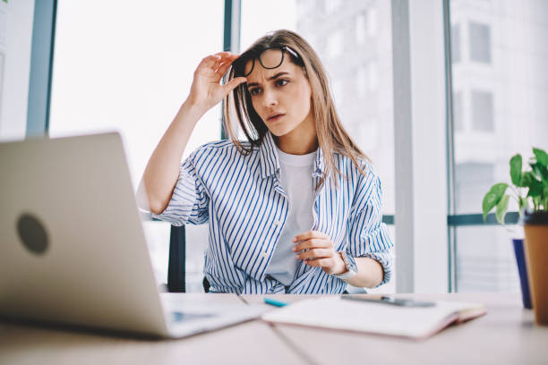 istock Unhappy female reading web article during journalistic research via laptop computer feeling puzzled on received information, Caucasian smart casual employee watching webinar video during e learning 1407094523