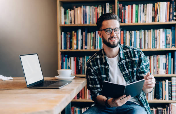 istock Cheerful freelancer working in literary cafe 1407097774