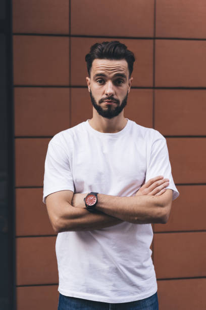 istock Surprised casual man standing near wall 1407097869