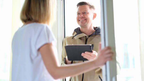istock Male courier delivering package and holding tablet with data 1407097961