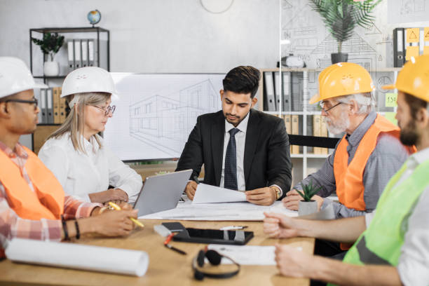 istock Team of construction designers, architects planning new project while sitting at office. 1407098568
