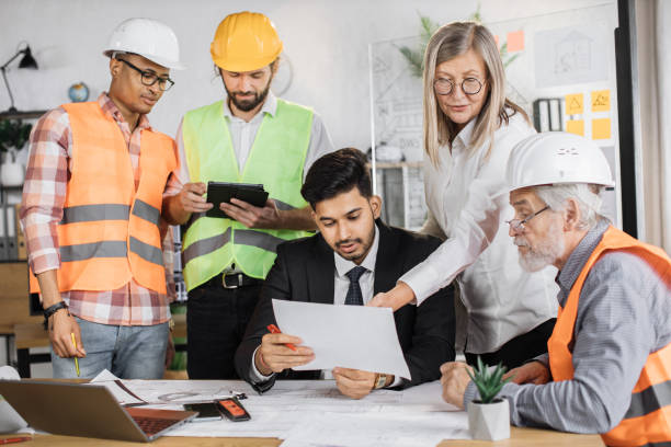 istock Group of five multi ethnic people cooperating together. 1407098629