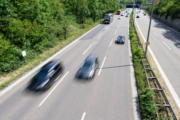 fast cars with motion blur on a cologne city highway from above