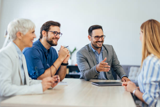 istock Close up of elegantly dressed people, working together, talking to each other. 1407098875