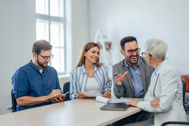 istock People at the workplace, working together, talking to each other. 1407098876