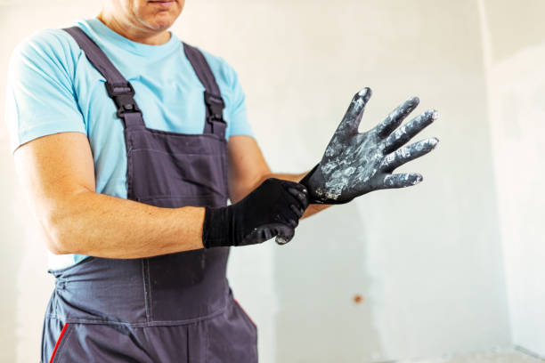 istock Man putting his gloves on before he starts his next job 1407098952