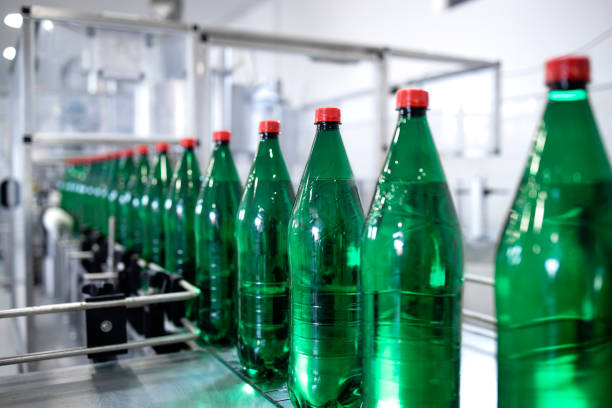 istock Bottled drinking water being transported on conveyor belt automated machine in beverage factory. 1407099295
