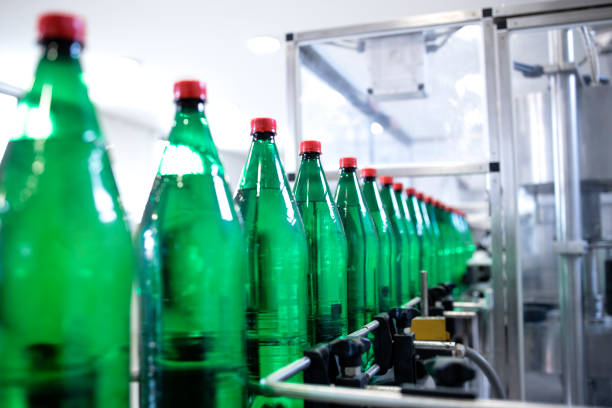 istock Plastic bottles on conveyor belt being filled with drinking water. 1407100605