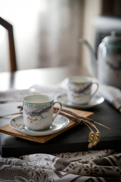 istock Breakfast or coffee break  in a rustic, intimate and cozy atmosphere. Cups of coffee or tea crafted on an ornate table. 1407100659