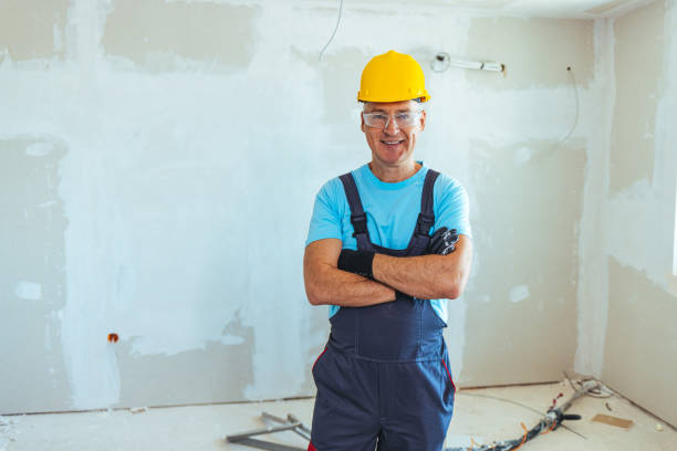 istock Portrait of smiling worker in blue uniform 1407101458