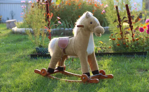Toy Rocking Horse On A Lawn In The Yard Of Private House