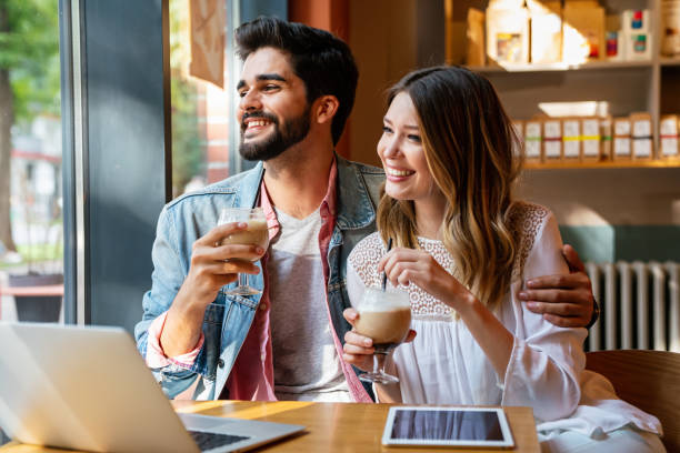 istock Romantic loving couple drinking coffee, having a date in the cafe. 1407102473