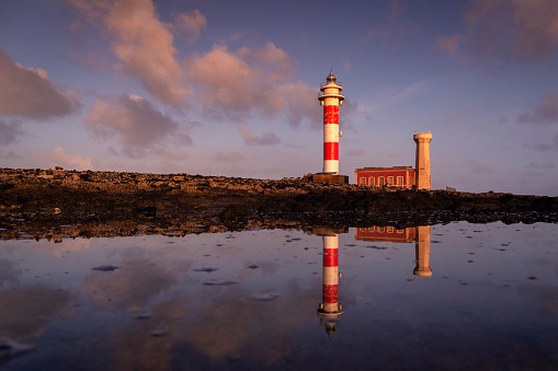 Beautiful sunrise with clouds at Toston lighthouse, El Cotillo, Fuerteventura, Canary Islands, Spain