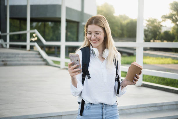 istock Portrait of a beautiful student using smartphone and enjoying coffee 1407105297