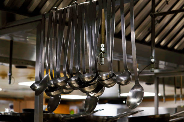 istock kitchen utensils like ladles and spatulas hanging on a rail 1407105441