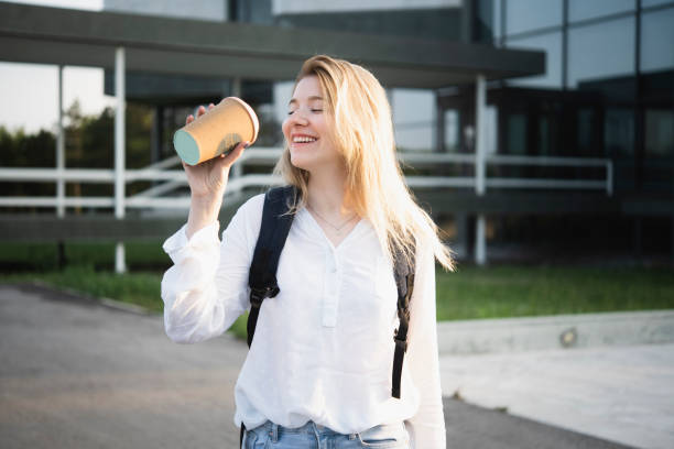 istock Beautiful student enjoying her coffee on the move 1407105971