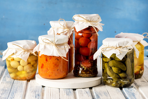 Jars of Tasty Pickled Vegetables Homemade Canned Food Blue and White Wooden Background Horizontal Harvest