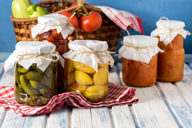 istock Marinated Cucumbers Tomatoes Squash Lecho in Jars are Located on Wooden Background Harvest for the Winter Horizontal 1407108363