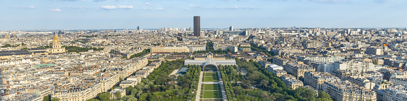 A view over the city of Paris, with the Eiffel Tower in the centre, and the modern office buildings of La Defense, the city's financial district, in the background.