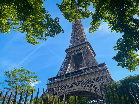 Close up of the Eiffel Tower on a spring day with blue sky in Paris, France