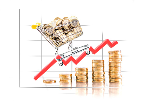 Graphic on coin towers showing the rise in the price of the shopping cart. Selective focus.