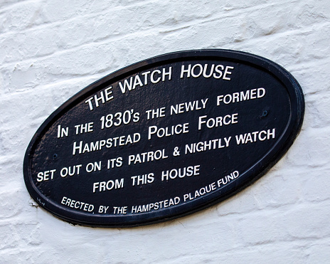 London, UK - May 19th 2022: Close-up of a plaque on the exterior of what once was Hampstead Watch House in the 1830s, located on Holly Walk in Hampstead, London, UK.