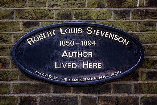 London, UK - May 19th 2022: A plaque located on Mount Vernon in Hampstead, London, UK, marking the location where famous author Robert Louis Stevenson once lived.