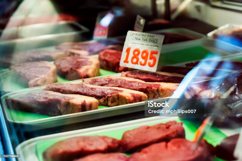 Inflation Rising Meat Prices Amish Meat Market View of fresh cut NY strip steak at indoor Pennsylvania Amish food market.  With the current recession and inflation meat prices have surged to record highs. Supermarket Stock Photo