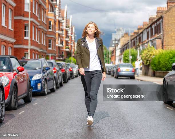Portrait Middle Of The Street Stock Photo - Download Image Now - Walking, Women, One Woman Only