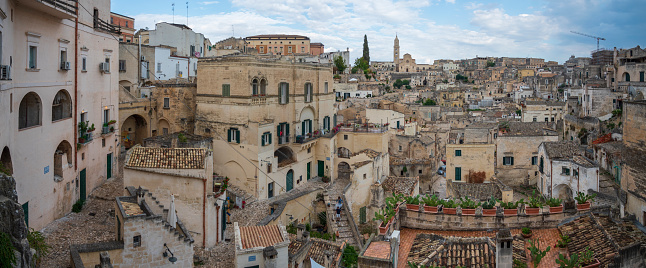 Matera is a city on a rocky outcrop in the region of Basilicata, in southern Italy. It includes the Sassi area, a complex of cave dwellings carved into the mountainside on September 2021. This is the most outstanding, intact example of a troglodyte settlement in the Mediterranean region.