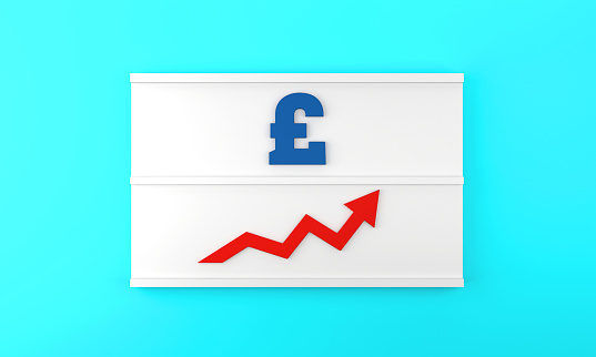 The Pound Symbol and the arrow pointing up are on the lightbox. Finance and economy concept.