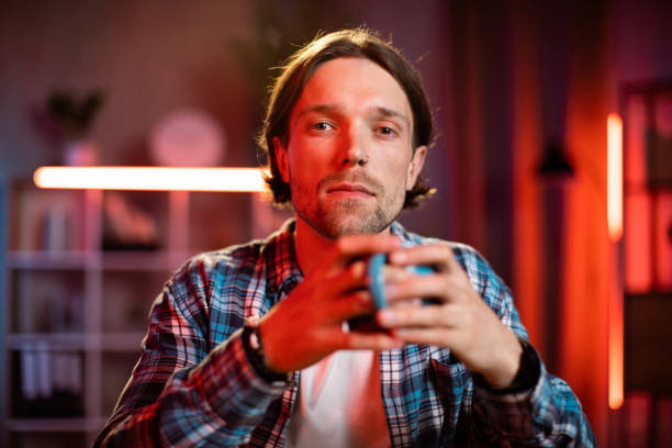 istock Confident young man drinking coffee or tea or hot drink at office. 1407121245