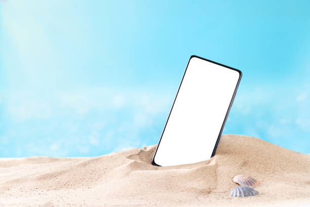 Smartphone with on the beach, copy-space Smartphone with white screen on sandy beach, copy space Iphone stock pictures, royalty-free photos & images