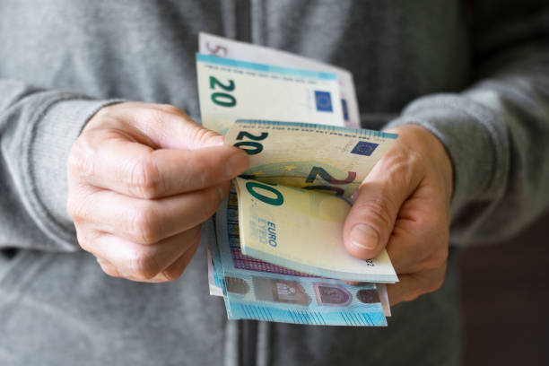 istock White female count euro bills in her hands 1407126323
