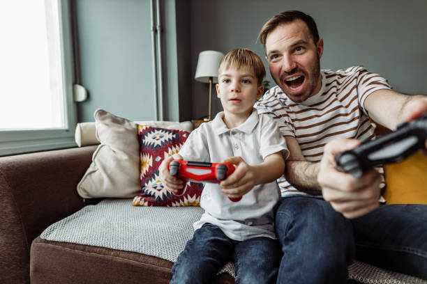 istock Father and son playing video games 1407127657