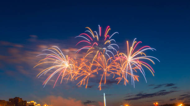 istock Fireworks light up the sky with dazzling display. Abstract colored firework background with free space for text. 1407129210