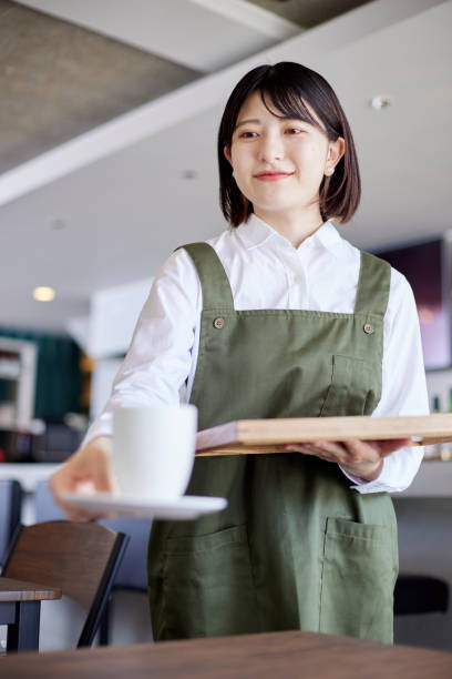 istock Young Japanese woman working at cafe 1407130875