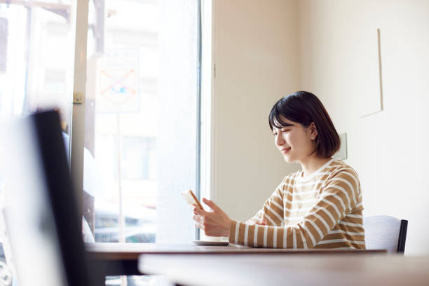 istock Young Japanese woman relaxing at cafe 1407130936