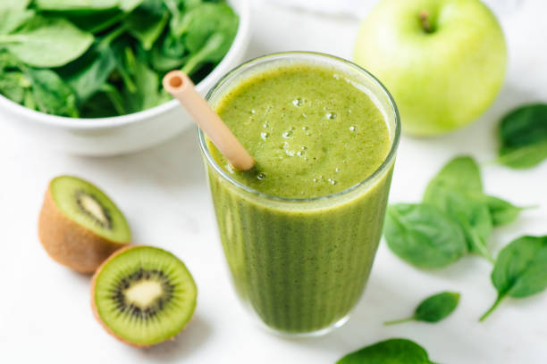 Detox green smoothie in glass stock photo