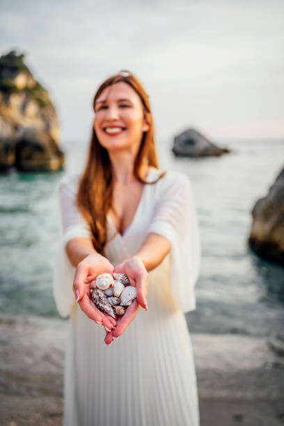 Woman holding seashells from the beach