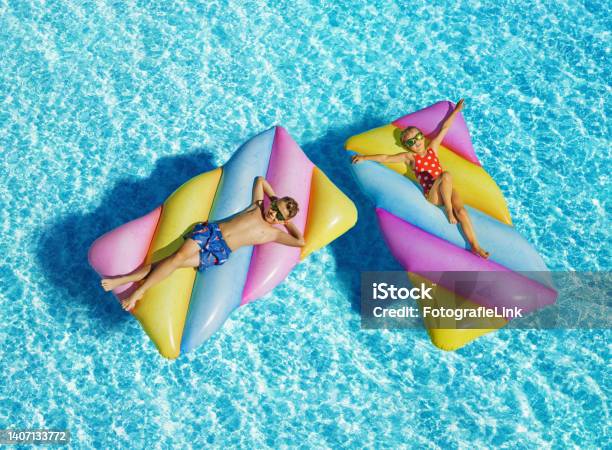 Funny Children On Inflatable Swimming Mattress In Pool Stock Photo - Download Image Now