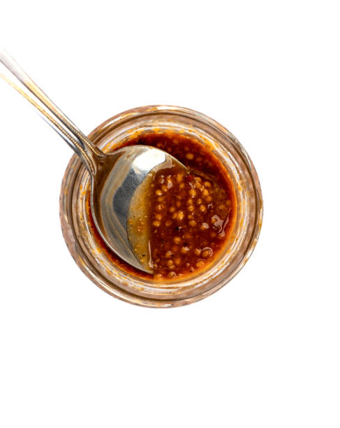 istock Spoon inside a glass jar with Bavarian mustard. 1407133885