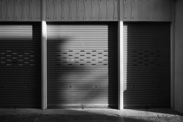 istock Black and white Old metal roller door background photo 1407135145