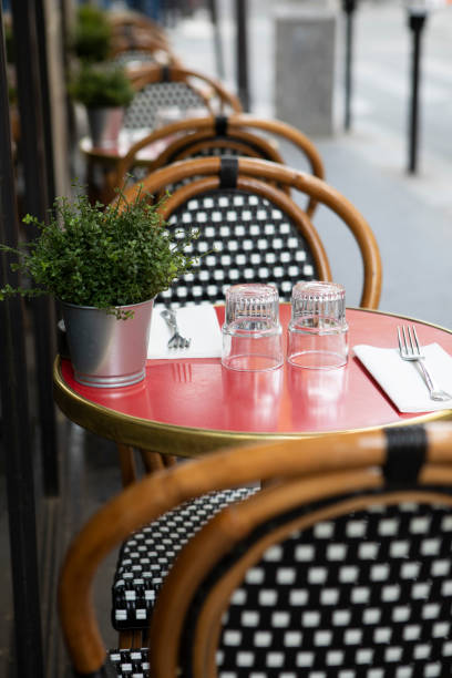 istock Table and chairs on the pavement outside a cafe in Paris 1407136637