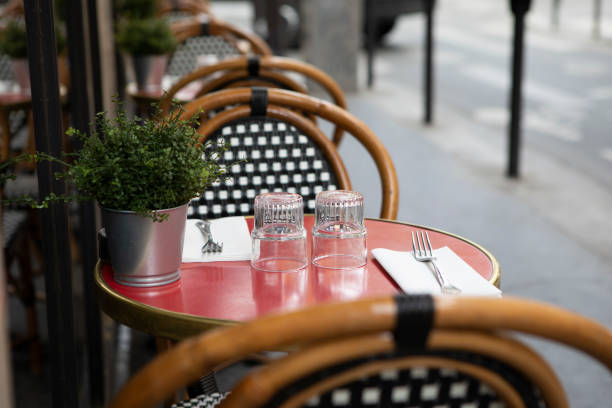 istock Table and chairs on the pavement outside a cafe in Paris 1407136641