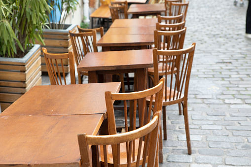 Wooden cafe tables and chairs in the Montmartre district of Paris