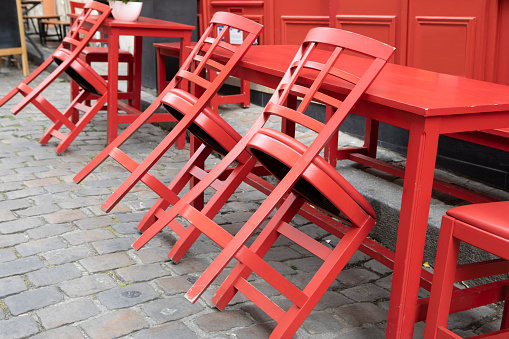 Red wooden cafe tables and chairs in the Montmartre district of Paris