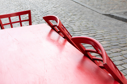 Red wooden cafe table and chairs in the Montmartre district of Paris