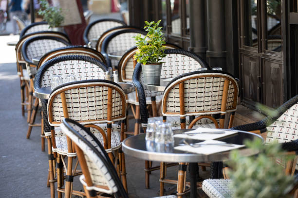 istock Tables and chairs on the pavement outside a cafe in Paris 1407136868