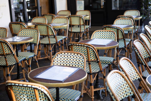 istock Circular cafe tables and chairs outside a cafe in Paris 1407136870